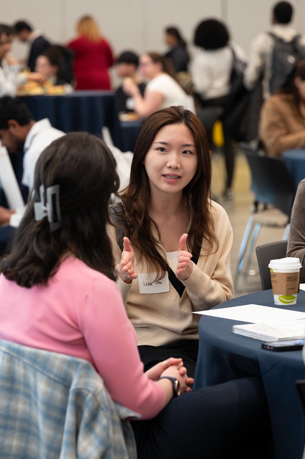 Students chatting at a table.